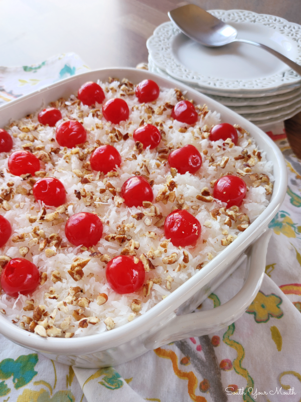 Italian Bakeless Cake! A layered no-bake dessert with vanilla wafers and creamy pineapple “pudding” made with sweetened condensed milk and lemon juice topped with cool whip, coconut, cherries and pecans.