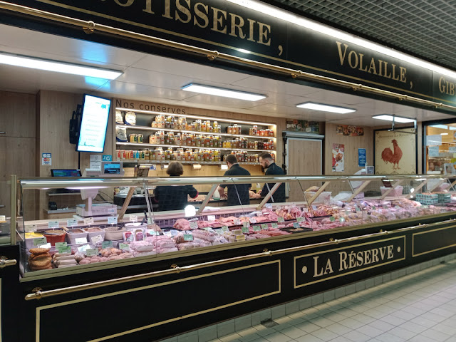 Poultry and game merchants in a covered market hall, Indre et Loire, France. Photo by Loire Valley Time Travel.