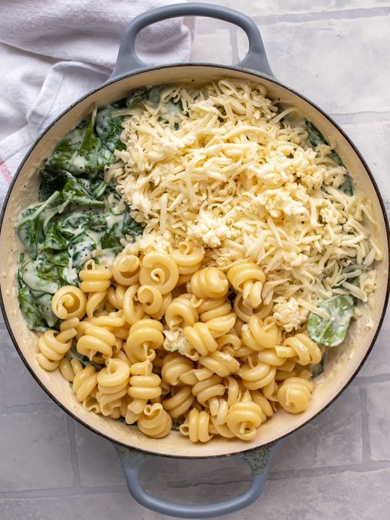 This creamed spinach mac and cheese is a dreamy, cheesy mac and cheese dish with tons of fresh baby spinach! Super comforting and flavorful.