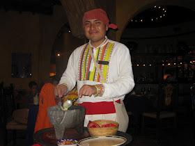 Waiter in traditional Mexican outfit in restaurant