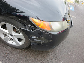 Honda Civic with damaged front bumper and fender before auto body repairs.