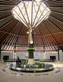 man waiting at baggage carousel