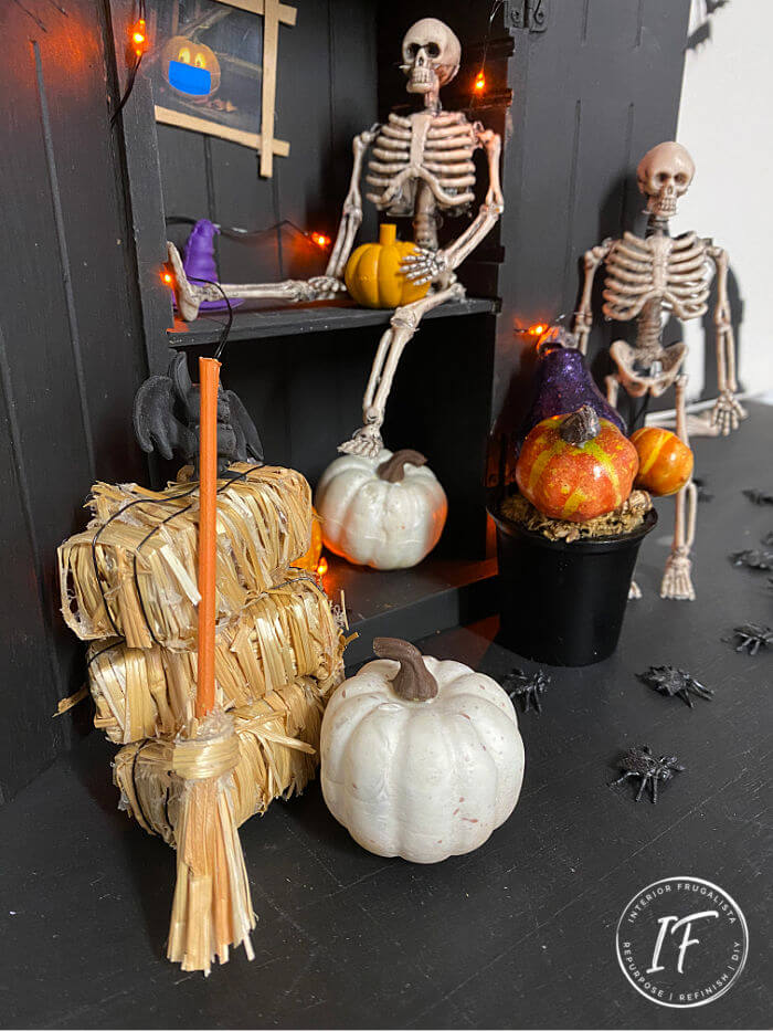 A Spooktacular Halloween Diorama Box made with an upcycled thrift store Figurine Display Shelf and inexpensive dollar store halloween decorations.