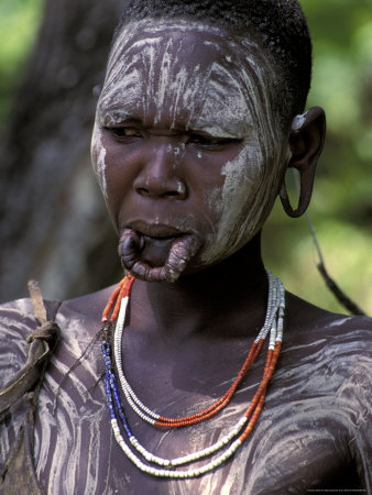 Surma women perform scarification by slicing their skin with a razor blade 