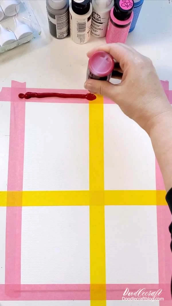 Pick a background color for the first box and squeeze a small bead of paint along the top edge of painters tape.