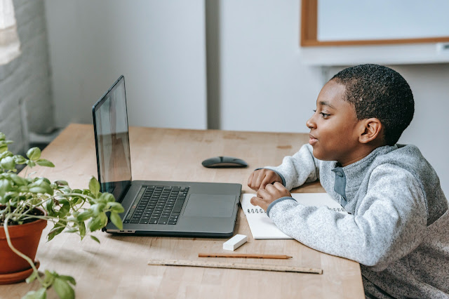 A boy Stay Focused in Online Classes and School with a laptop