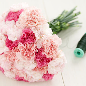 A beautiful bridal bouquet with pink carnations and green foliage