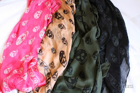 Alexander McQueen silk skull scarves in neon pink, blush pink, olive green, and black and gray