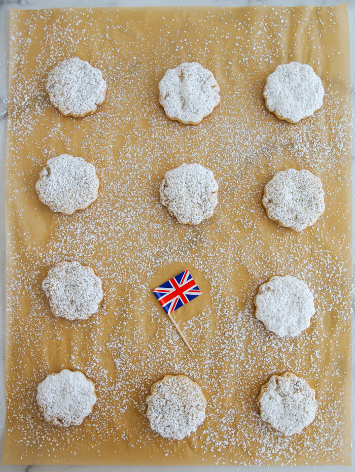Queenies Cookies on parchment in rows with British flag