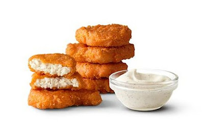 A 6-piece order of McDonald's Spicy Chicken McNuggets with dipping sauce.
