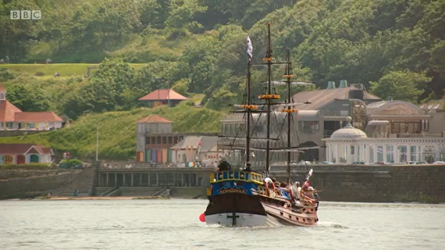 The Hispaniola with Scarborough Spa, beach huts and Clock Cafe in background. From All at Sea Episode 4.