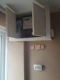 The Old Fuse Board and Electricity Meter in a Cupboard