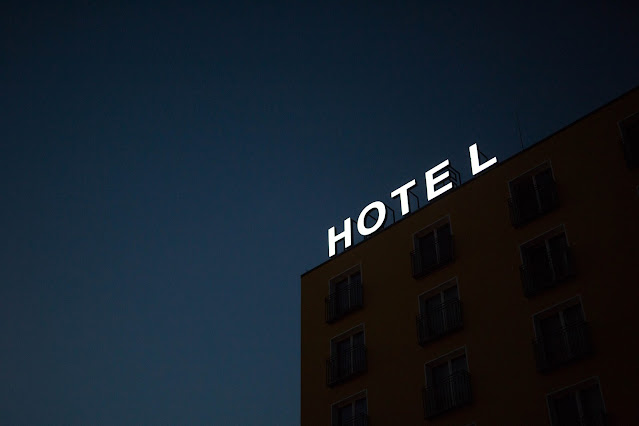 illuminated hotel sign:Photo by Marten Bjork on Unsplash
