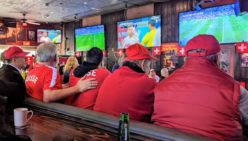 Swiss fans in red all watch the match