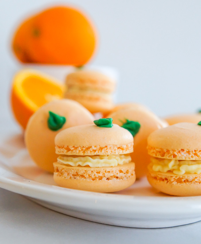 Orange Macarons with oranges in background
