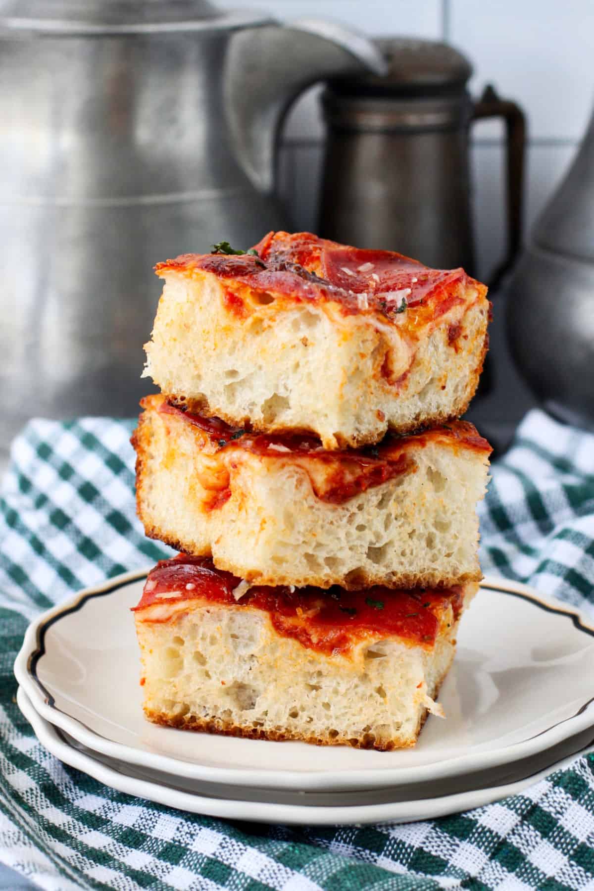 Pepperoni and Mushroom Pan Pizza pieces, stacked.