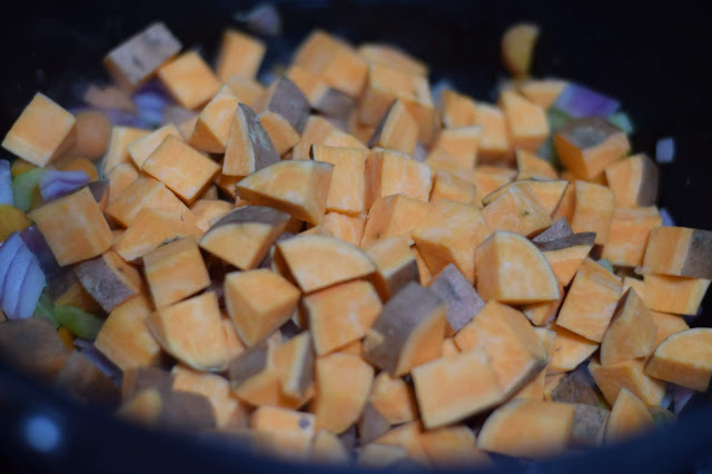 Diced sweet potatoes being added to the pot. 