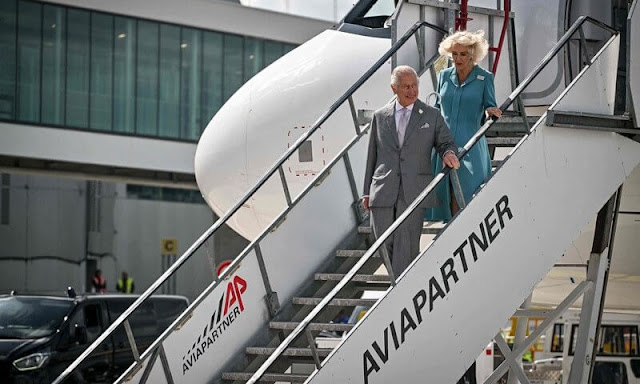 Queen Camilla wore a blue dress coat, and floral print midi dress. Diamond brooch. HMS Iron Duke