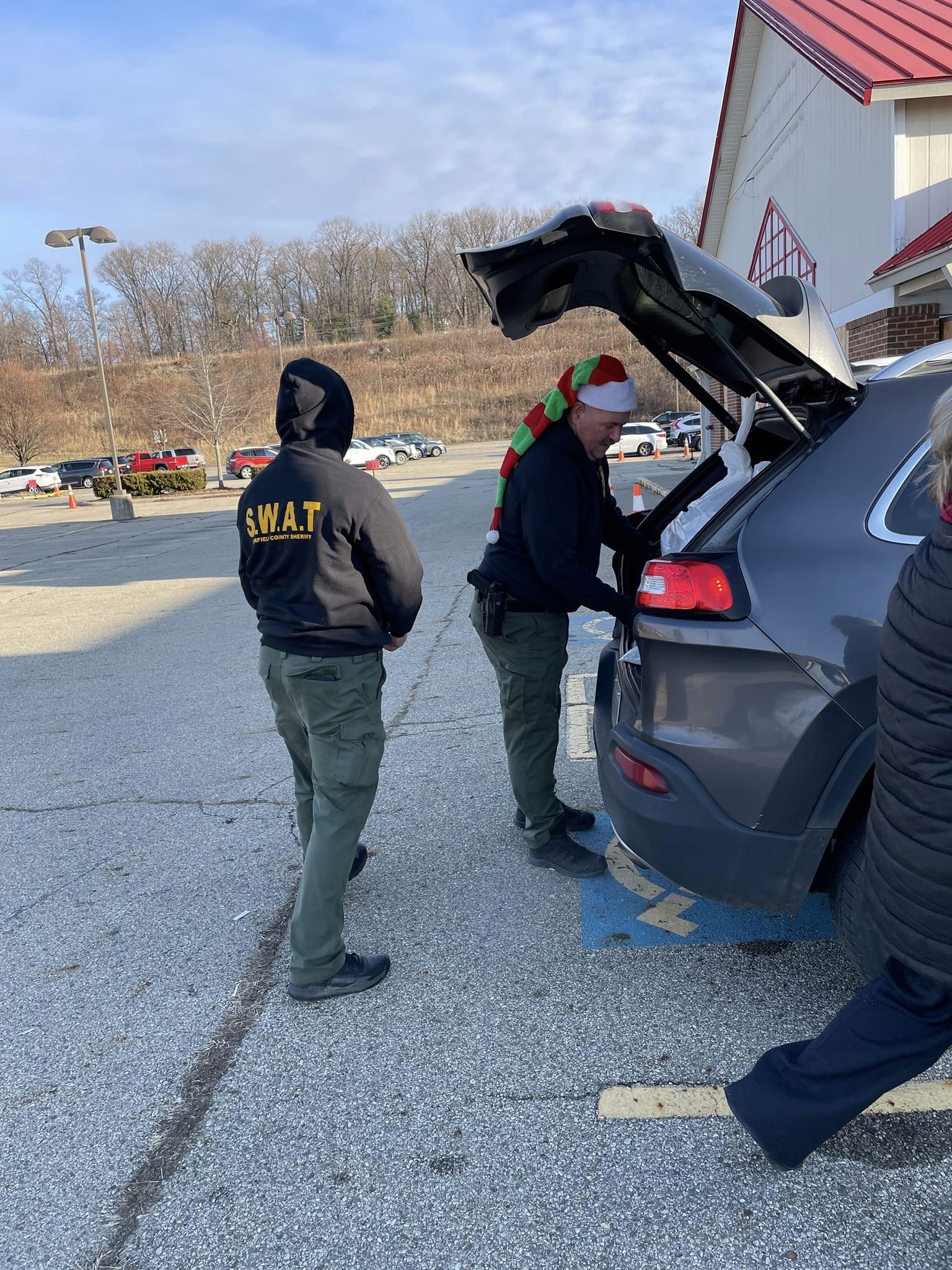 man getting into car trunk