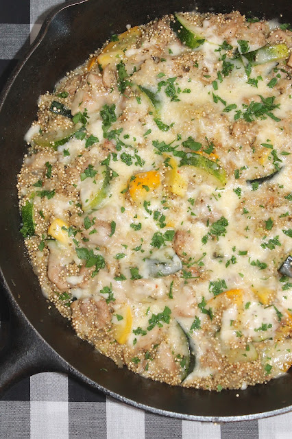 Skillet chicken and summer squash quinoa topped with cheese.