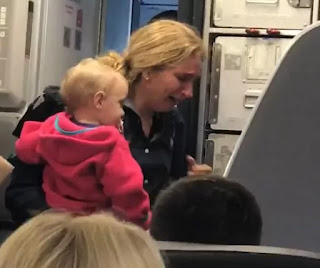 woman crying on american airline plane