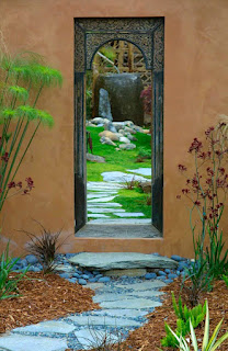 A path leading through a doorway and into a garden.