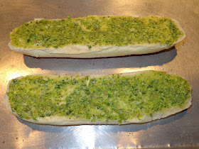 GARLIC BREAD INGREDIENTS 1 large hero bread, cut in half length wise 5 garlic cloves, minced 2 tbsp. chopped parsley 1 tbsp. room temperature butter 1 tbsp. olive oil METHOD Place garlic and parsley in a mortar and with a pestle crush it into a paste. Add, olive oil, butter and mix it in. Add the garlic paste to both inside of the hero bread. Place the bread in a baking sheet pan and toast it at low broil.