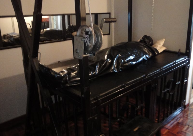 this gimp be put in rubber sleepsack inflatable rubber hood and force feed 