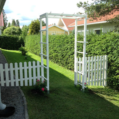 Valkoinen puinen portti puutarhaan