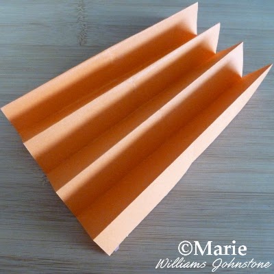 Orange color paper which has been folded in a concertina accordion fold