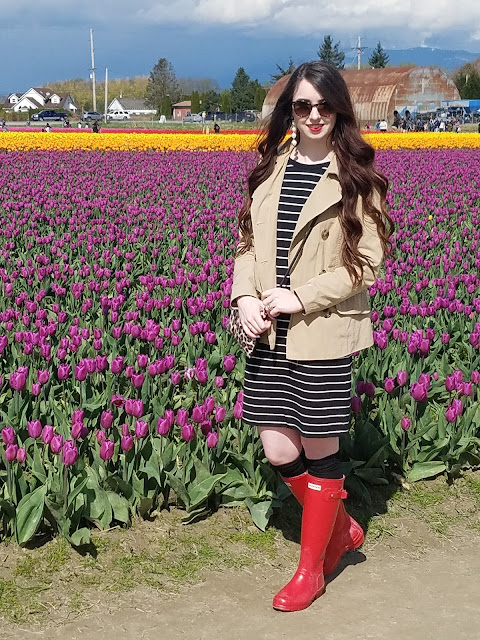 pair red Hunter rain boots with a dress and trench