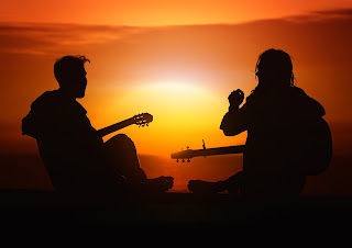 playing guitars against the sunset