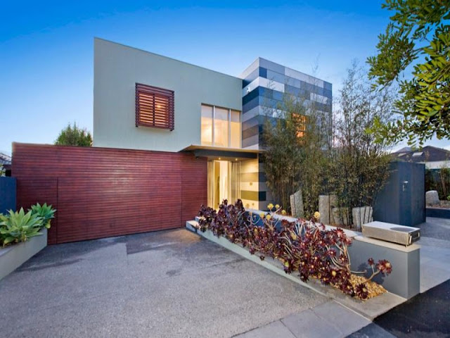 Photo of front side of modern home as seen from the street