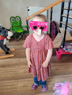 Rosie showing off her new glasses (still in the packing)