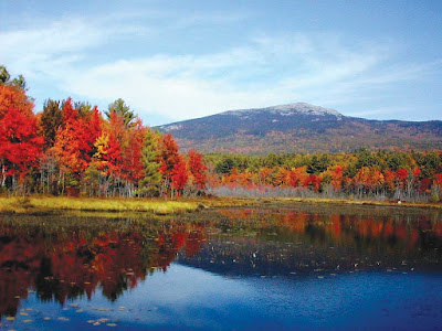 Mount Monadnock surrounded by colorful foliage and a lake at