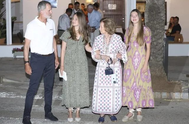 Queen Letizia wore a red pleated halter-neck dress by Mango. Infanta Sofia wore an Ikat Arles dress by Babbaki