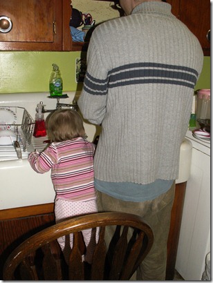 Elaine doing dishes with daddy