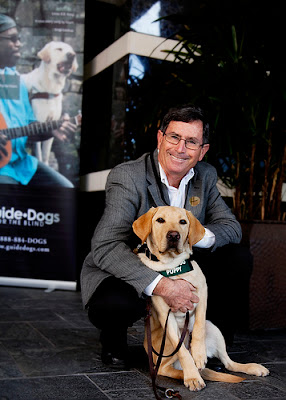 Puppy raiser and Orange County Friends Committee member Pete Egus with a yellow Lab Guide Dog puppy