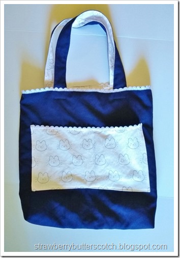 The finished navy blue bag with cute pink pockets, lining, and lace trim.