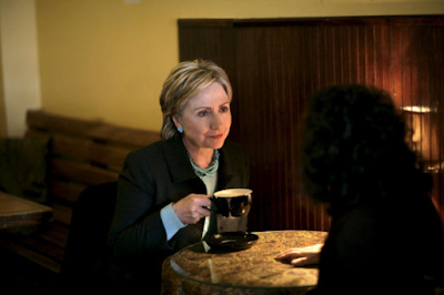 Hillary Clinton meets with  constituent as she held a cup of coffee during the 2008 presidential campaign. Photo by Brooks Kraft.