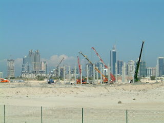 Constructing the Dubai Humanitarian City with Dubai's Sheikh Zayed skyline in the background - click for full size view