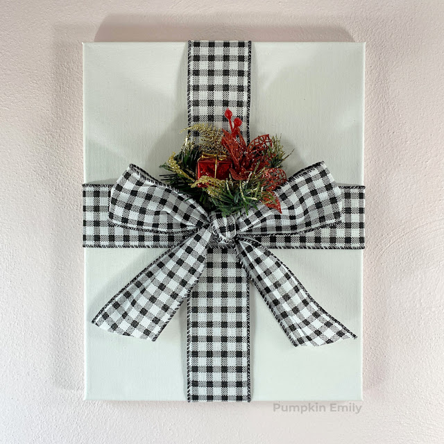 A Christmas canvas that looks like a present.