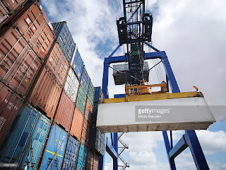  Shipping containers with gantry crane. (Credit: Cultura Creative (RF)/Alamy Stock Photo) Click to Enlarge.