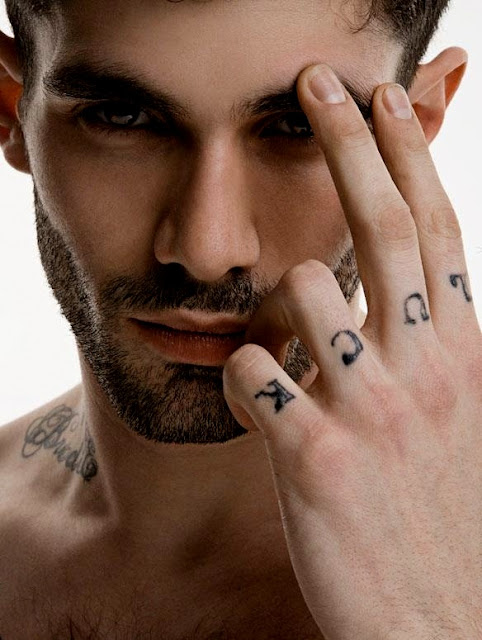 model with luck tattoo fingers