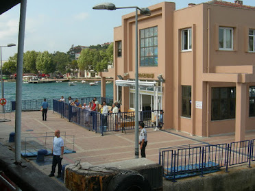 The open-air view of a restaurant in Buyukada, located at the sea's edge.