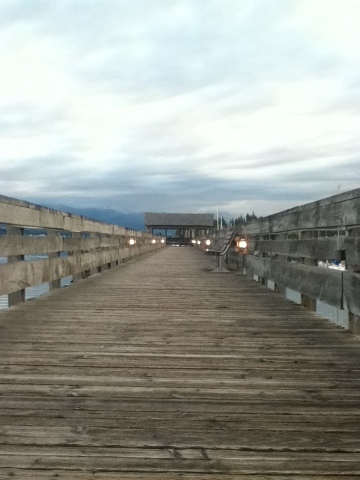 Comox Marina boardwalk lit up in evening light