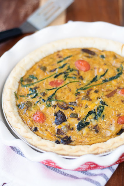 The finished Easy Vegan Just Egg Vegetable Quiche Recipe in a decorative pie plate.