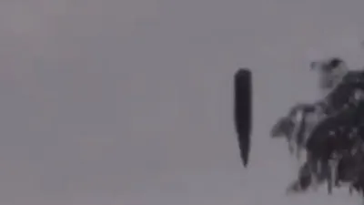 Black cylinder shape UFO filmed over Russia.