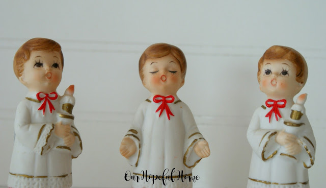 Vintage porcelain choir boys in robes with candles made in Japan.