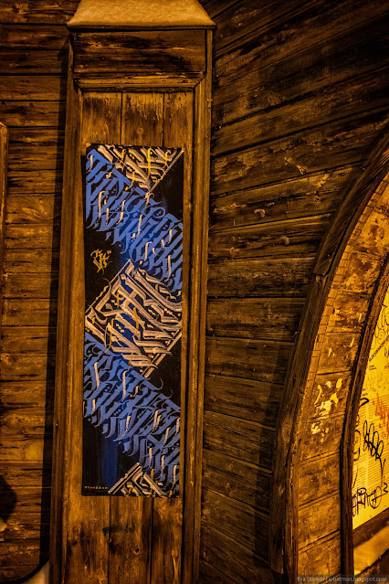 Табличка с абстрактными надписями на деревянном доме